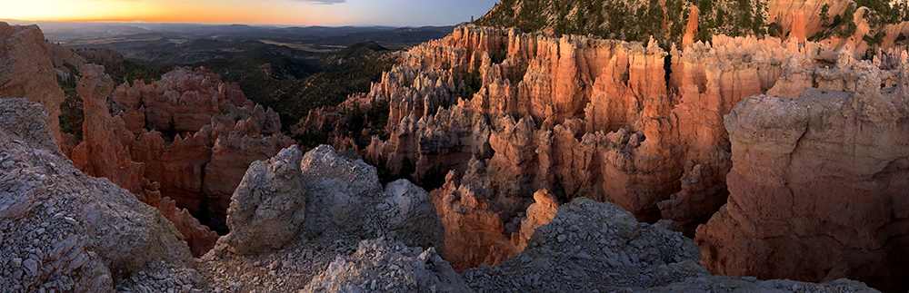 Hoodoos glow red at sunrise on the Under the Rim Trail.