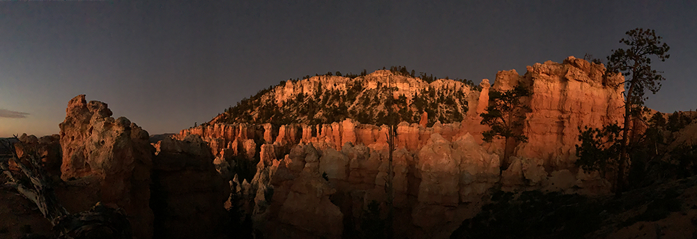 early morning sun hits the red cliffs of bryce