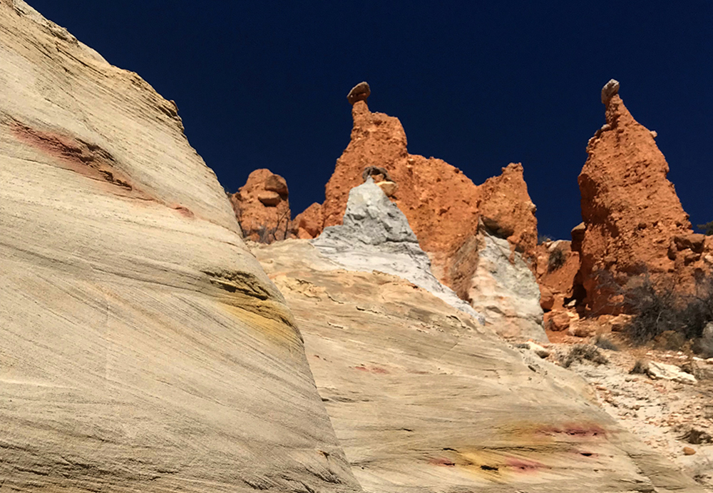 the towering hoodoos of the hat shop are topped with stones that appear as hats