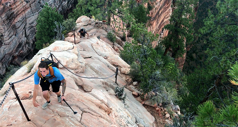 hikers make their way up the chains of the exposed angels landing trail
