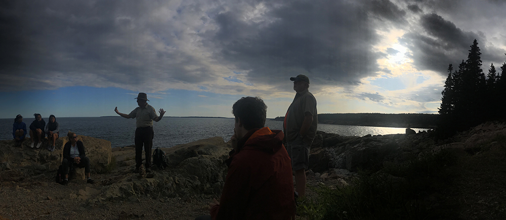 a park ranger leads a nature walk along the otter cliffs in acadia