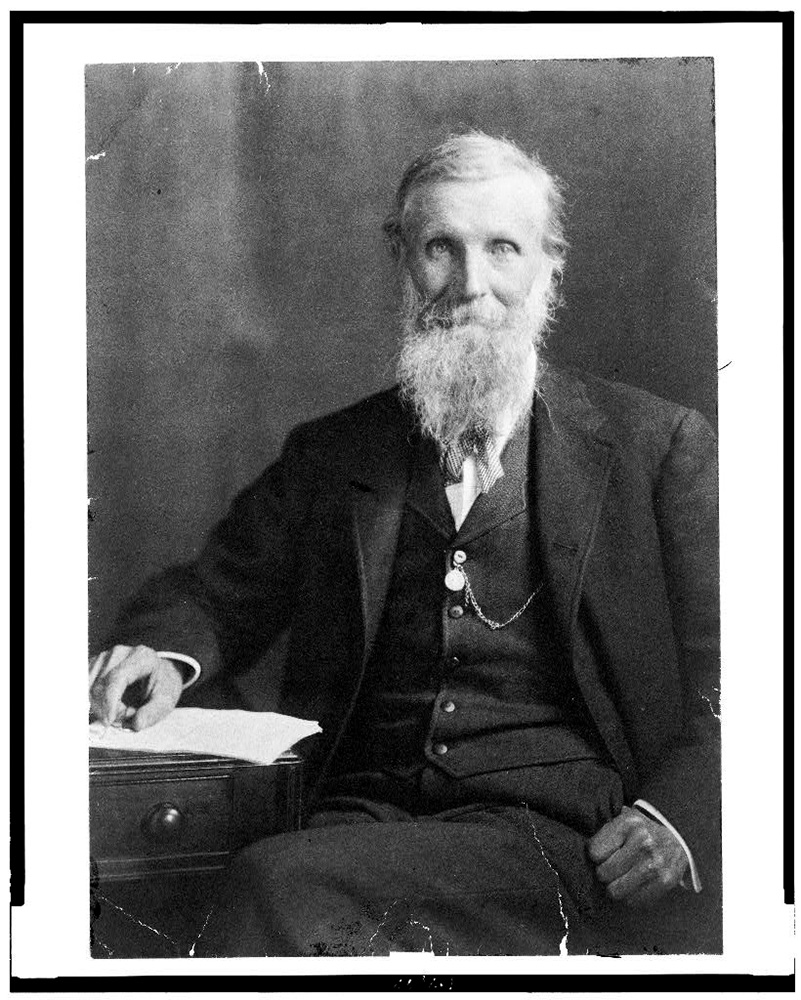 john muir the author at a desk